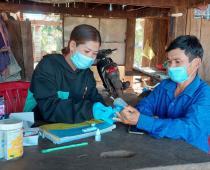 Village Malaria Worker Ms. Srey Touch conducts a malaria rapid diagnostic test in her village. Photo: UNOPS ARHC
