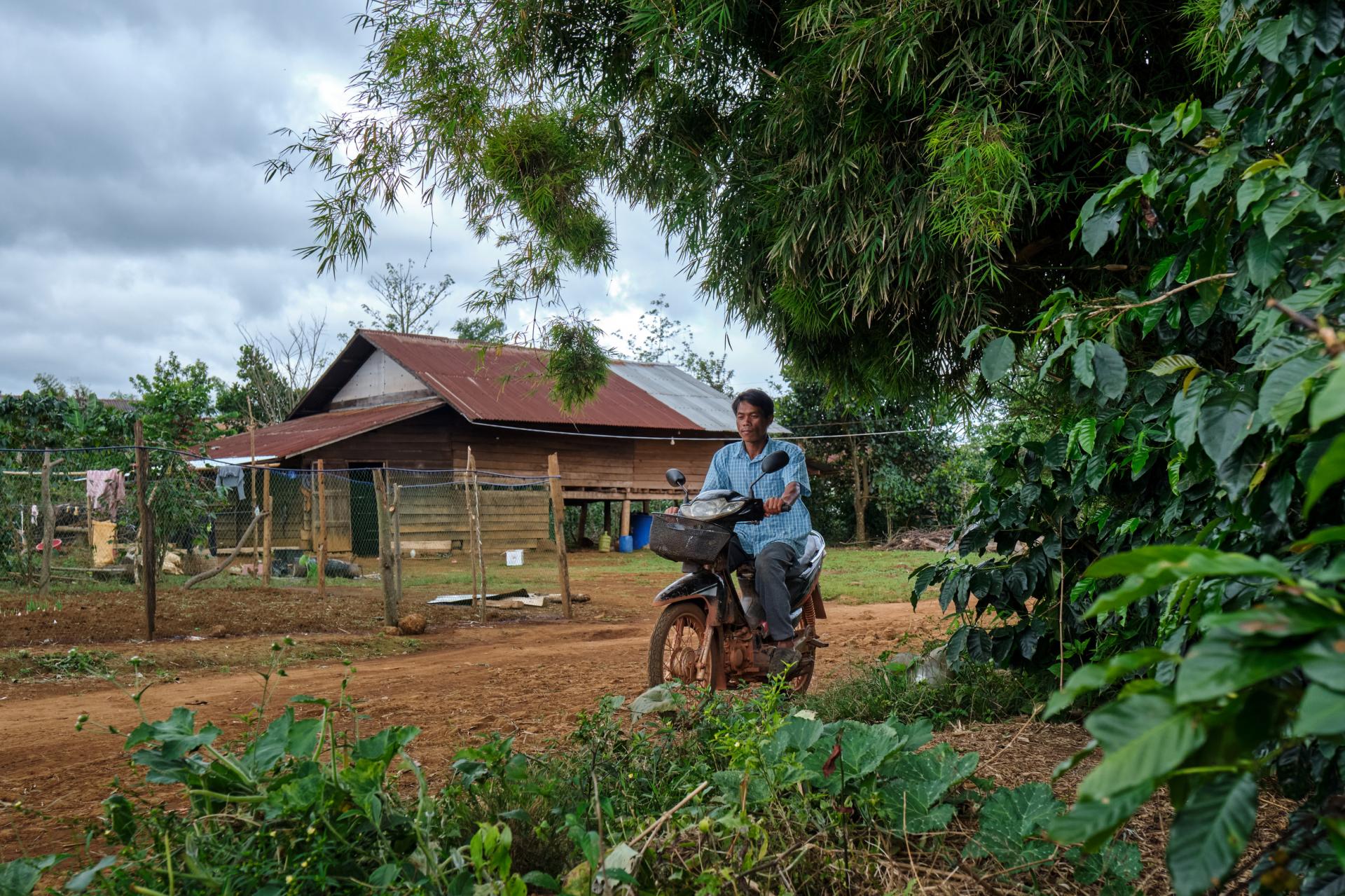 Village malaria worker Sisomphang conducting home visits on his motorbike. Photo: BART VERWEIJ