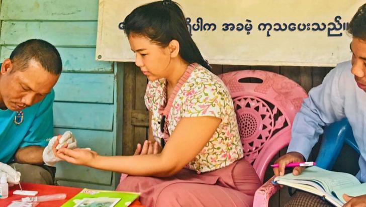 U Myo San, MHAA-trained integrated community malaria volunteer, performs a malaria rapid diagnostic test for Thidar Aung, Malaria Programme Associate, UNOPS-PR, during a field monitoring visit to, Samee 2-Quarter village, Paletwa, Chin State. RDT allows the diagnosis of malaria in 15 minutes, significantly cutting the time between blood sample and diagnosis. Photo: UNOPS