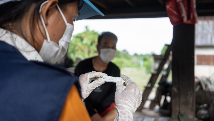 Village Malaria Worker Khounmy conducting a malaria test in her village. Photo: WHO/Enric Catala