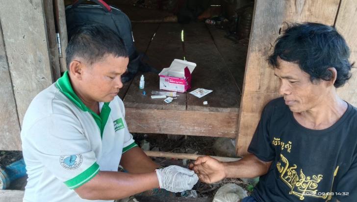 Mobile malaria worker, San, draws a blood sample from a forest-goer to perform a malaria rapid diagnostic test in O’Kasing village, Stung Treng province, Cambodia. Photo: Malaria Consortium 
